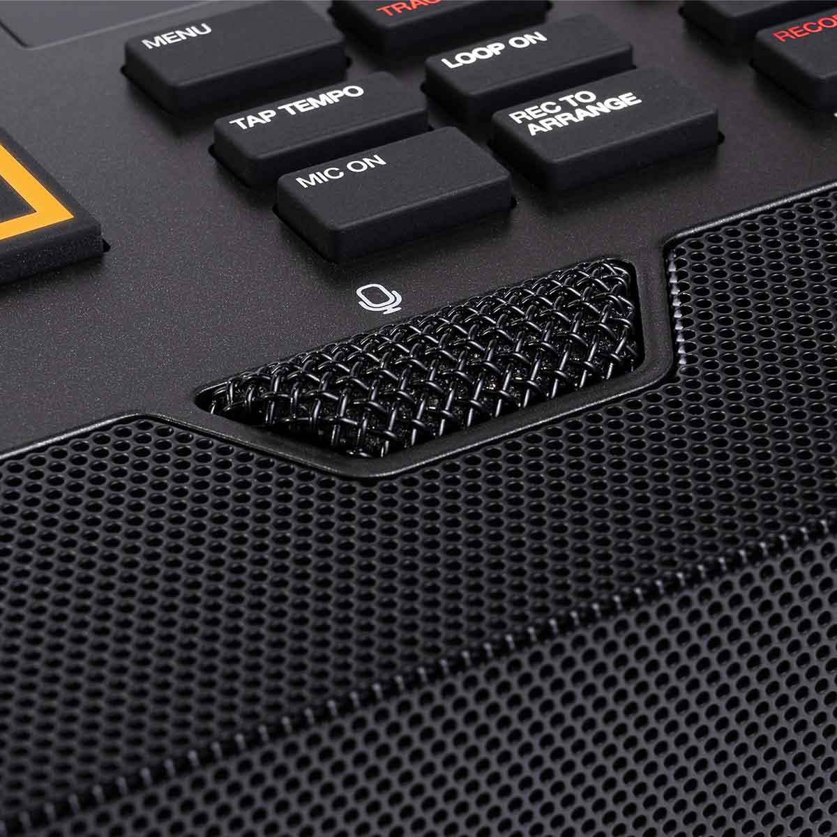 Close-up of a black electronic device with control buttons and a mesh panel on Akai MPC Live 3